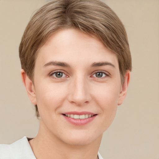 Joyful white young-adult female with short  brown hair and grey eyes