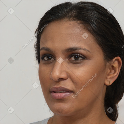 Joyful black adult female with medium  brown hair and brown eyes