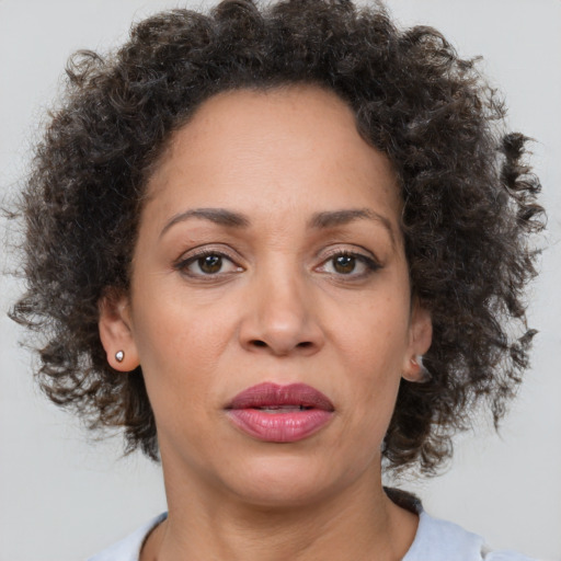 Joyful black adult female with medium  brown hair and brown eyes