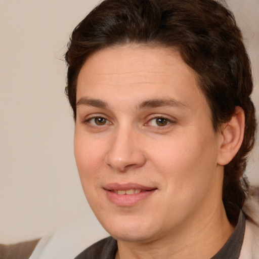 Joyful white adult female with medium  brown hair and brown eyes