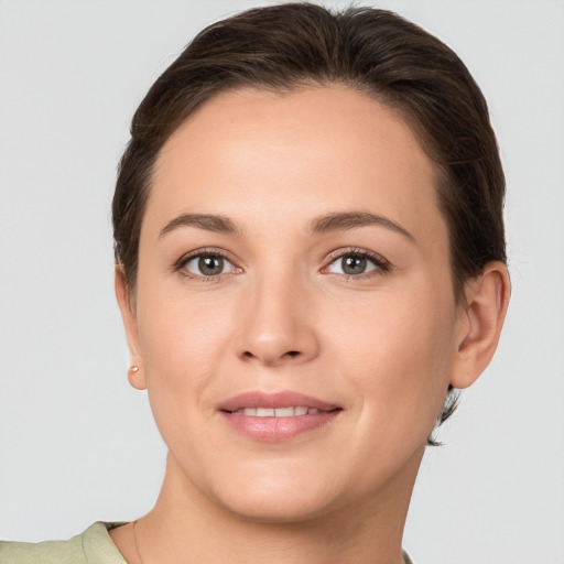 Joyful white young-adult female with short  brown hair and brown eyes