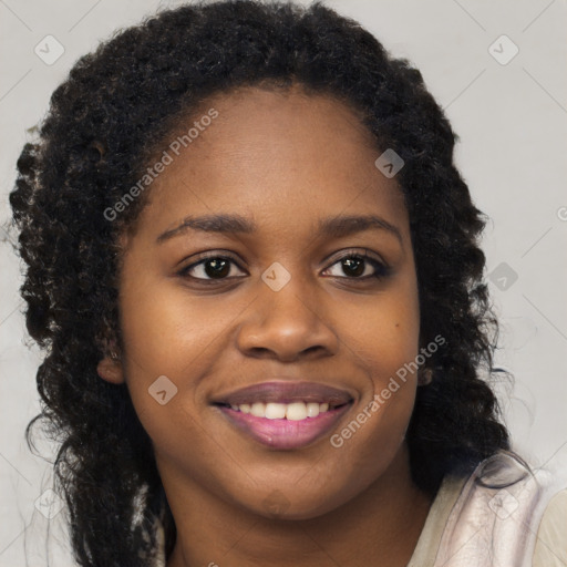 Joyful black young-adult female with long  black hair and brown eyes