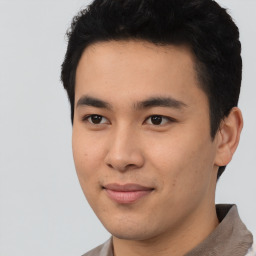 Joyful asian young-adult male with short  black hair and brown eyes