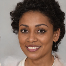 Joyful black young-adult female with medium  brown hair and brown eyes