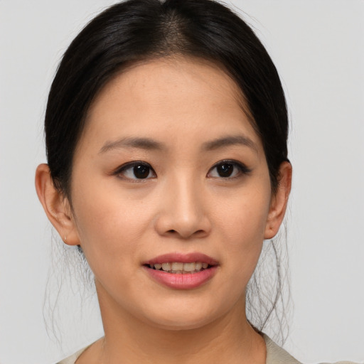 Joyful asian young-adult female with medium  brown hair and brown eyes