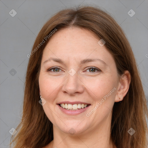 Joyful white adult female with long  brown hair and grey eyes