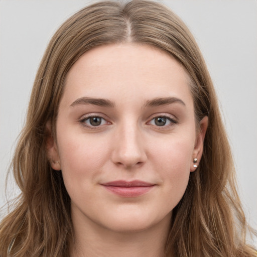 Joyful white young-adult female with long  brown hair and grey eyes