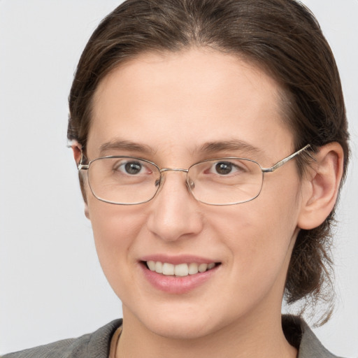 Joyful white adult female with medium  brown hair and grey eyes