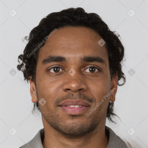 Joyful black young-adult male with short  brown hair and brown eyes