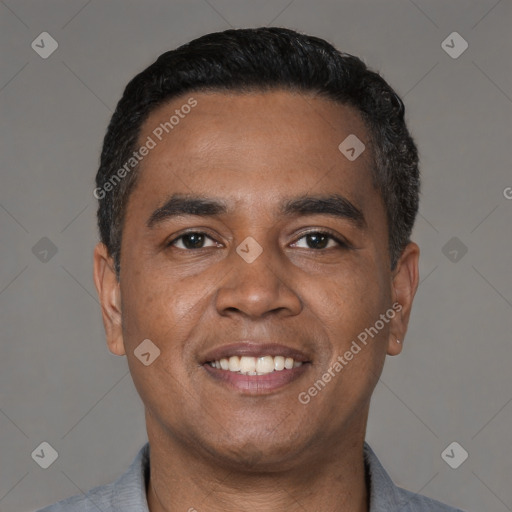 Joyful latino young-adult male with short  black hair and brown eyes