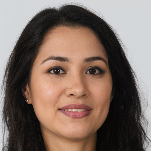 Joyful latino young-adult female with long  brown hair and brown eyes