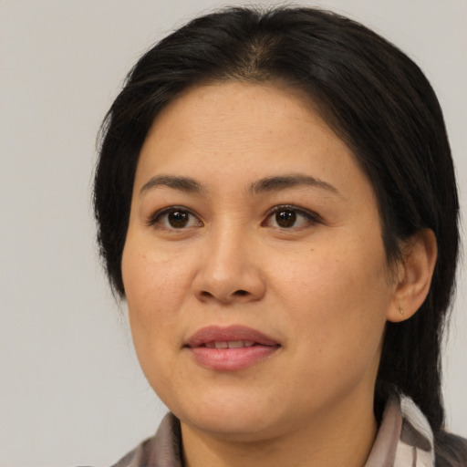 Joyful asian young-adult female with medium  brown hair and brown eyes