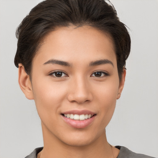 Joyful white young-adult female with short  brown hair and brown eyes