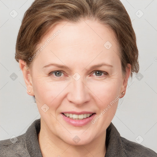 Joyful white adult female with medium  brown hair and grey eyes