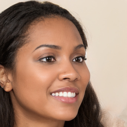 Joyful latino young-adult female with long  brown hair and brown eyes