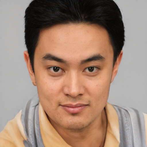 Joyful latino young-adult male with short  black hair and brown eyes