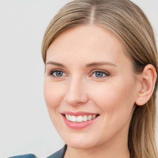 Joyful white young-adult female with long  brown hair and blue eyes