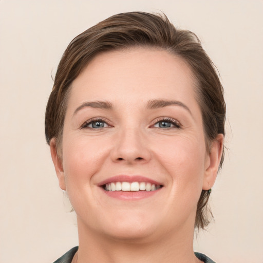 Joyful white young-adult female with medium  brown hair and grey eyes