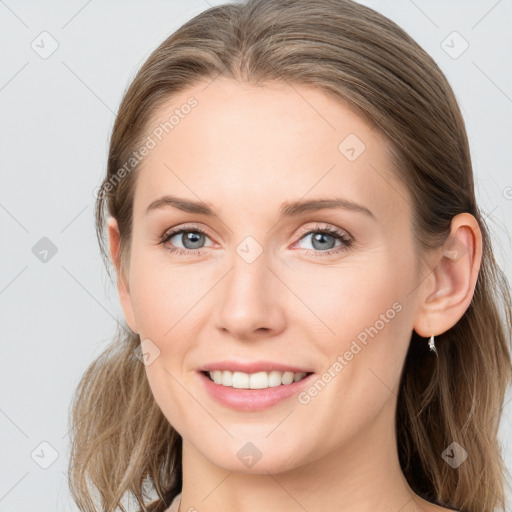 Joyful white young-adult female with long  brown hair and blue eyes