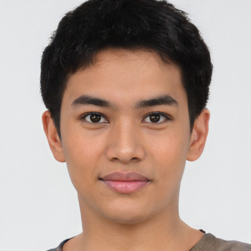 Joyful latino young-adult male with short  brown hair and brown eyes