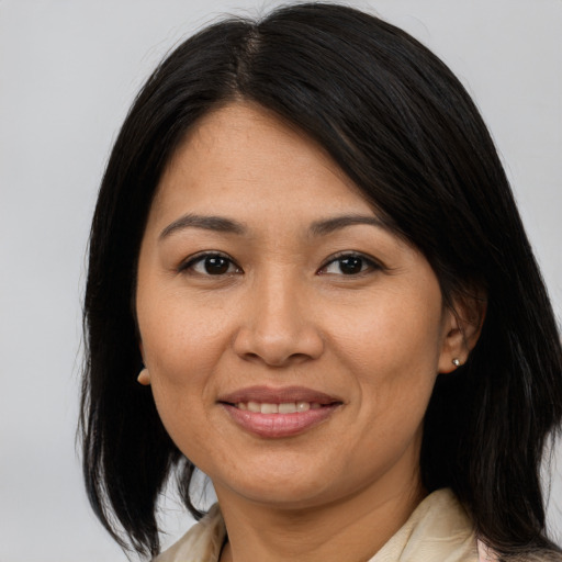 Joyful asian adult female with medium  brown hair and brown eyes