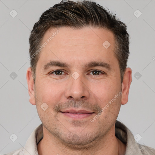 Joyful white adult male with short  brown hair and brown eyes