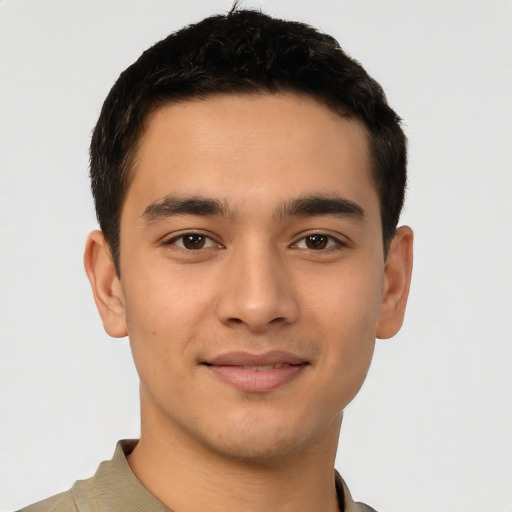Joyful latino young-adult male with short  brown hair and brown eyes