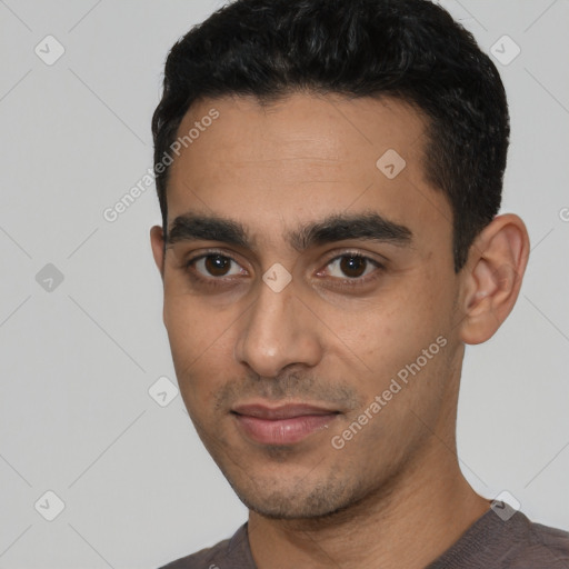 Joyful latino young-adult male with short  black hair and brown eyes