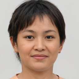 Joyful asian young-adult female with short  brown hair and brown eyes