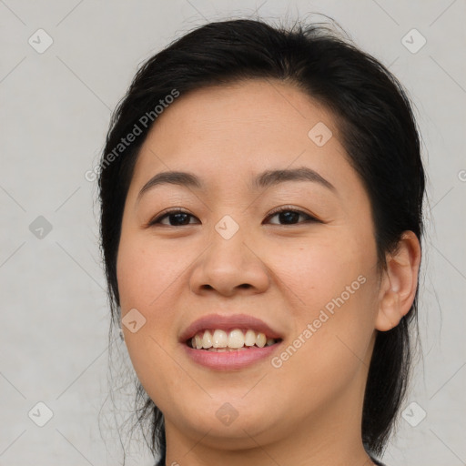 Joyful asian young-adult female with medium  brown hair and brown eyes