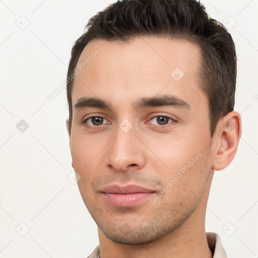 Joyful white young-adult male with short  brown hair and brown eyes