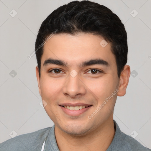 Joyful white young-adult male with short  black hair and brown eyes