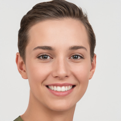 Joyful white young-adult female with short  brown hair and brown eyes