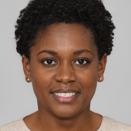 Joyful black young-adult female with short  black hair and brown eyes