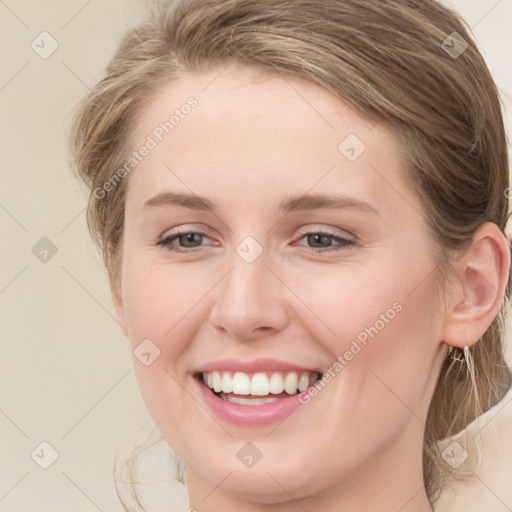 Joyful white young-adult female with medium  brown hair and green eyes