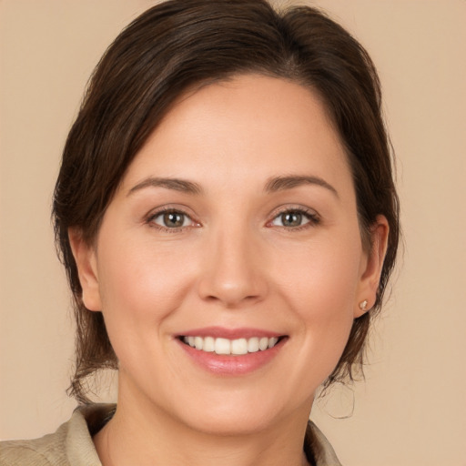 Joyful white young-adult female with medium  brown hair and brown eyes