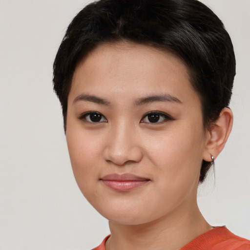 Joyful asian young-adult female with short  brown hair and brown eyes