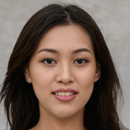 Joyful white young-adult female with long  brown hair and brown eyes