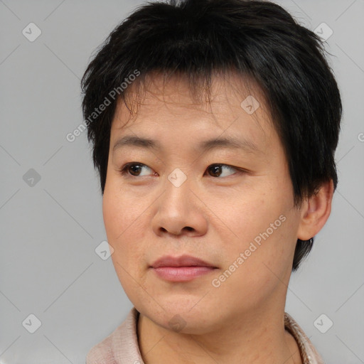 Joyful asian young-adult male with short  brown hair and brown eyes
