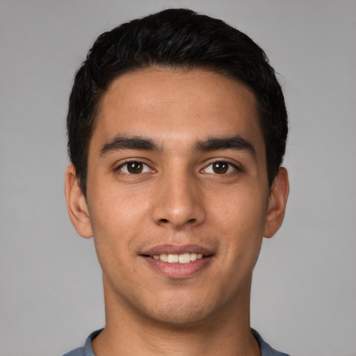 Joyful white young-adult male with short  black hair and brown eyes