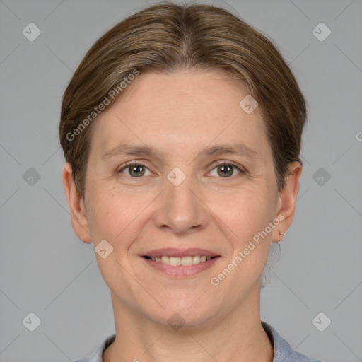 Joyful white adult female with short  brown hair and grey eyes