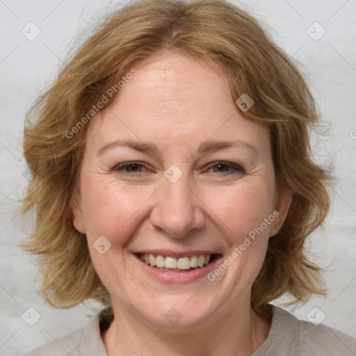 Joyful white adult female with medium  brown hair and blue eyes