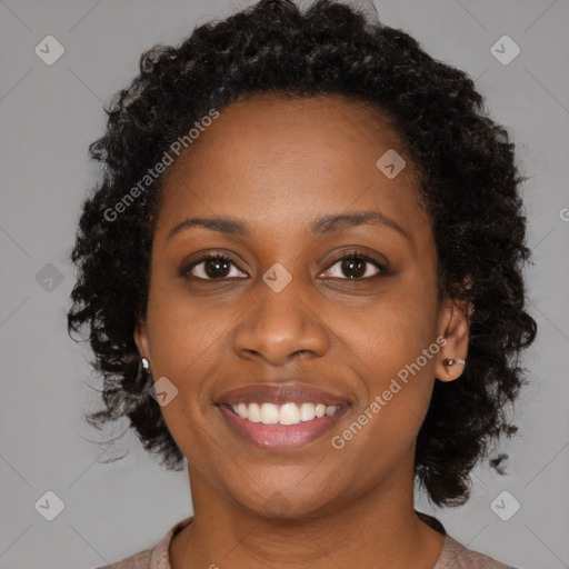 Joyful black young-adult female with medium  brown hair and brown eyes