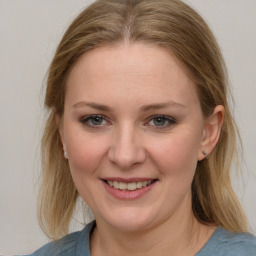 Joyful white young-adult female with medium  brown hair and blue eyes