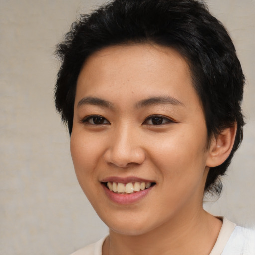 Joyful asian young-adult female with short  black hair and brown eyes