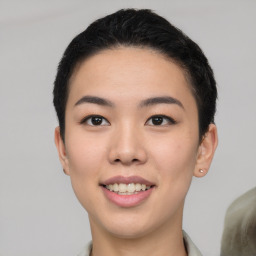 Joyful asian young-adult female with short  black hair and brown eyes