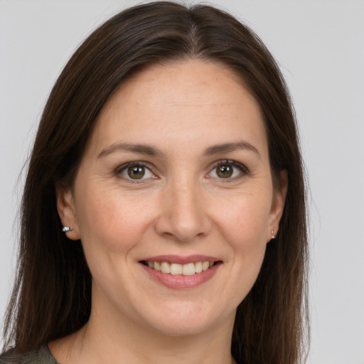 Joyful white young-adult female with long  brown hair and brown eyes