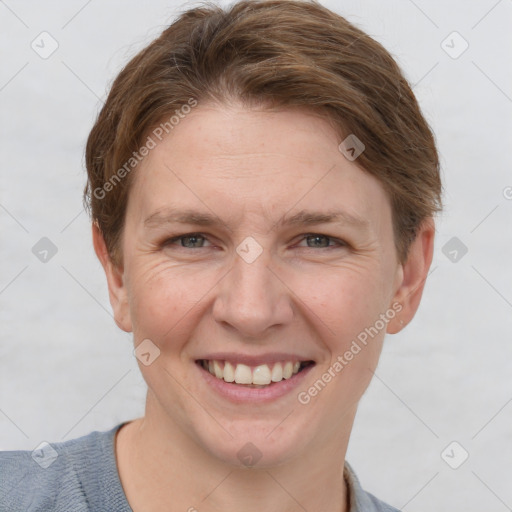 Joyful white adult female with short  brown hair and grey eyes