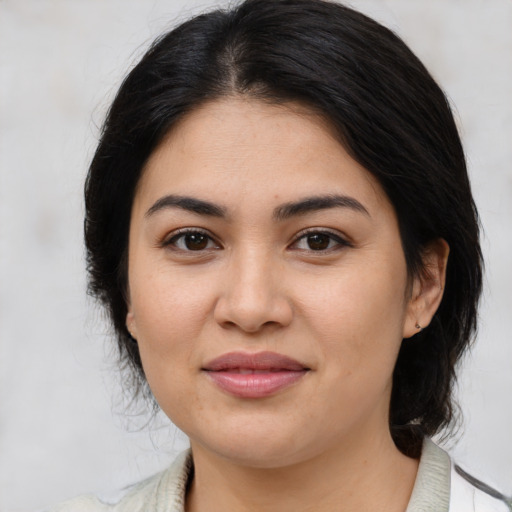 Joyful latino young-adult female with medium  brown hair and brown eyes