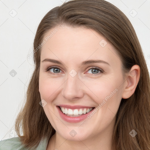 Joyful white young-adult female with long  brown hair and blue eyes